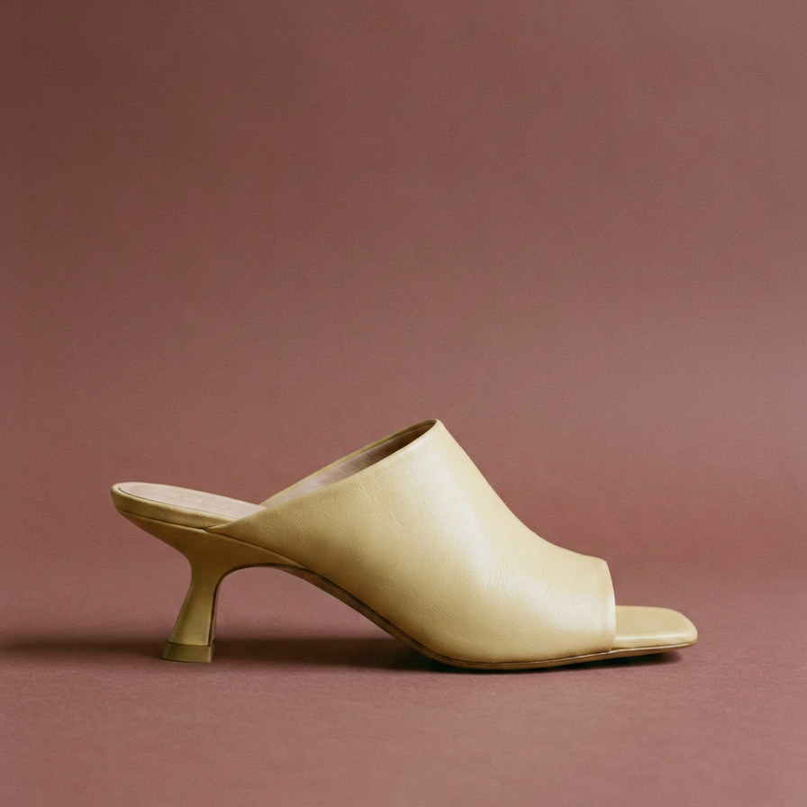 butter yellow mule on a soft oxblood background